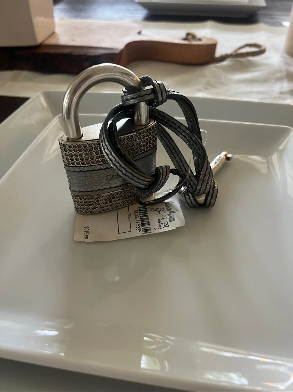 : Chloé • Padlock & key • Metallic leather strap • Textured metal detailing •